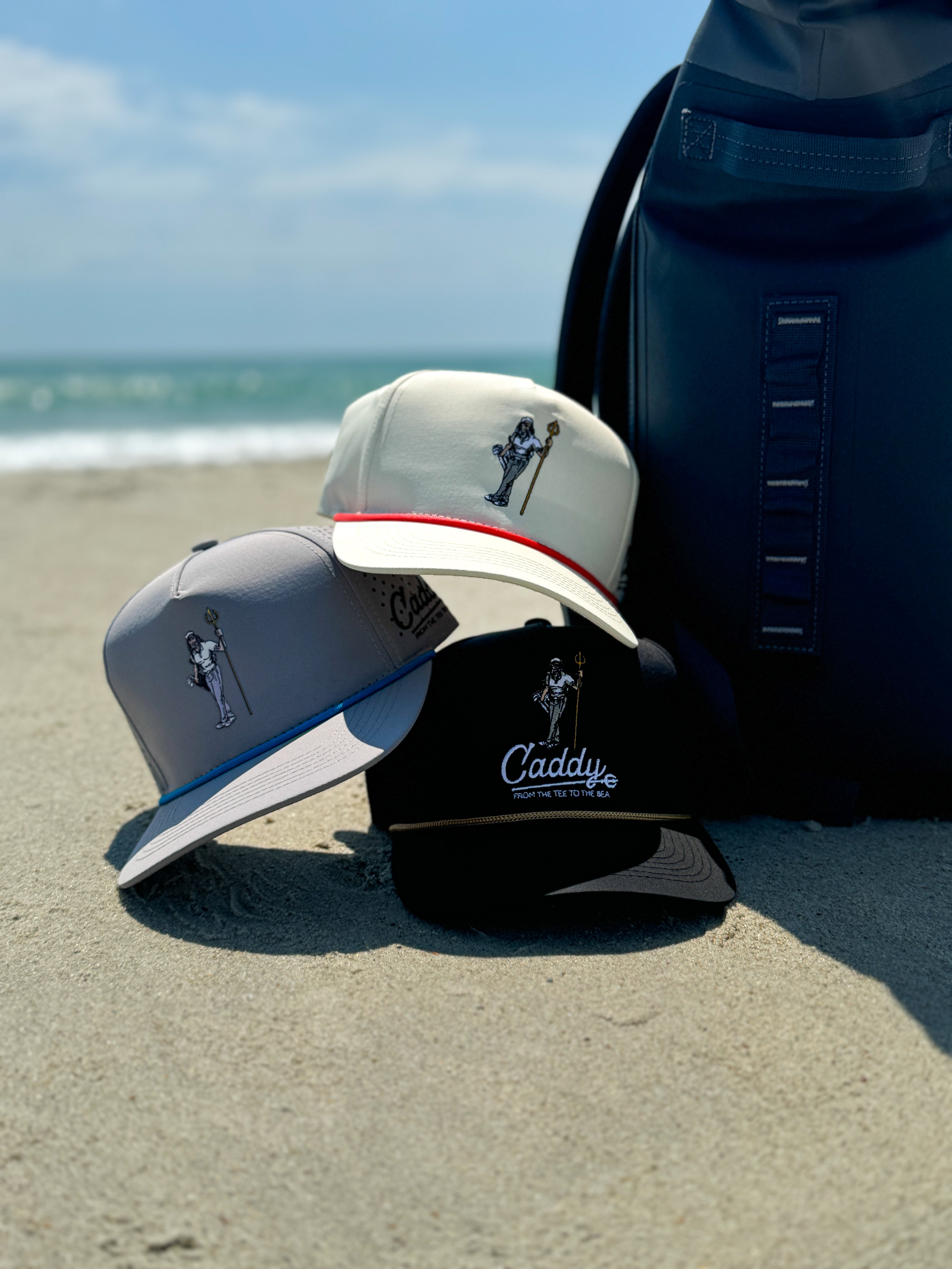 hats stacked on top of each other on the beach